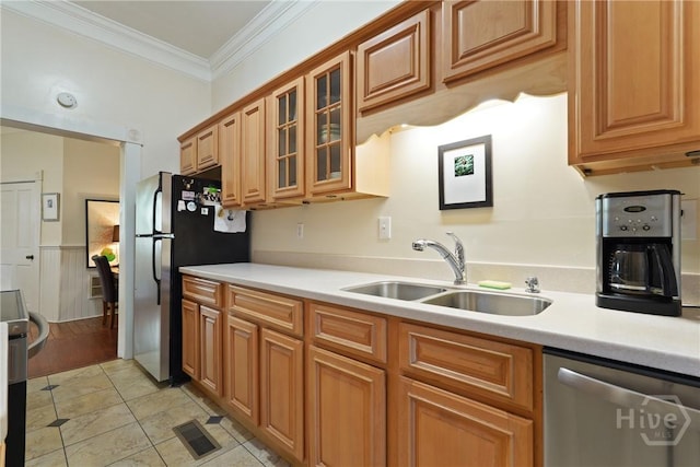 542 E Gaston St Unit A, Savannah, GA 31401 - kitchen with stainless steel appliances, a sink, light countertops, crown molding, and glass insert cabinets