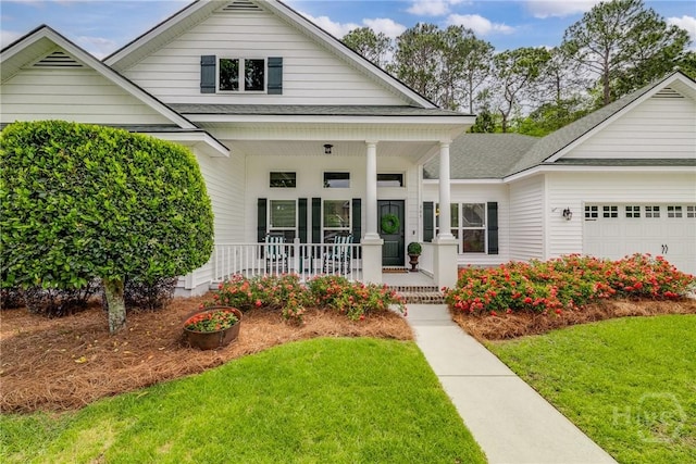 305 Windsor Rd, Guyton, GA 31312 - view of front of home with covered porch, a front lawn, a garage, and a shingled roof