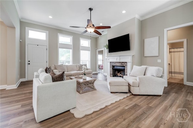 305 Windsor Rd, Guyton, GA 31312 - living area with ceiling fan, crown molding, baseboards, light wood-style floors, and a fireplace