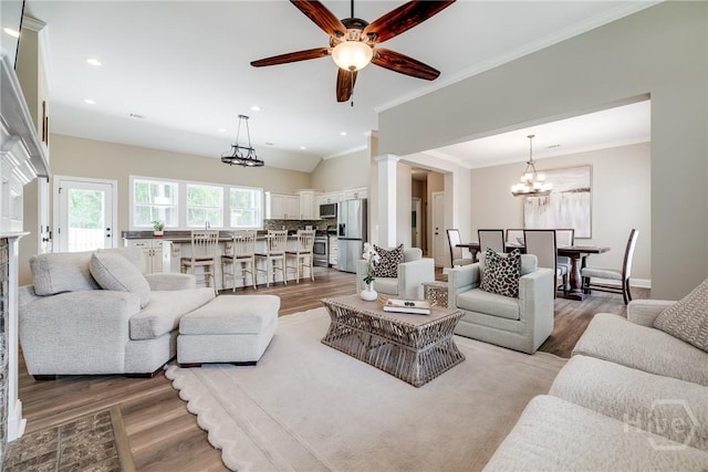 305 Windsor Rd, Guyton, GA 31312 - living area featuring light wood-style floors, a chandelier, a ceiling fan, ornamental molding, and recessed lighting