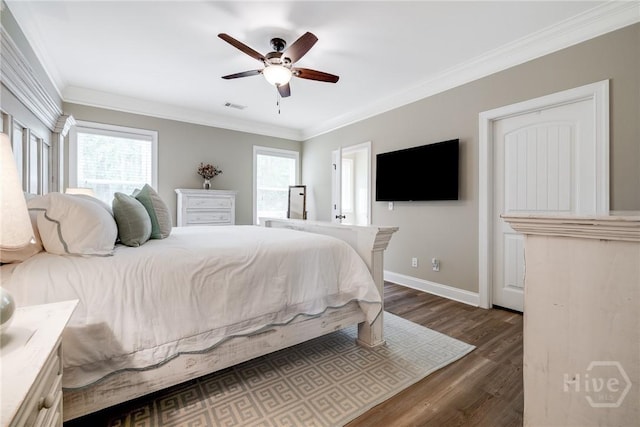 bedroom with multiple windows, dark wood finished floors, crown molding, baseboards, and ceiling fan