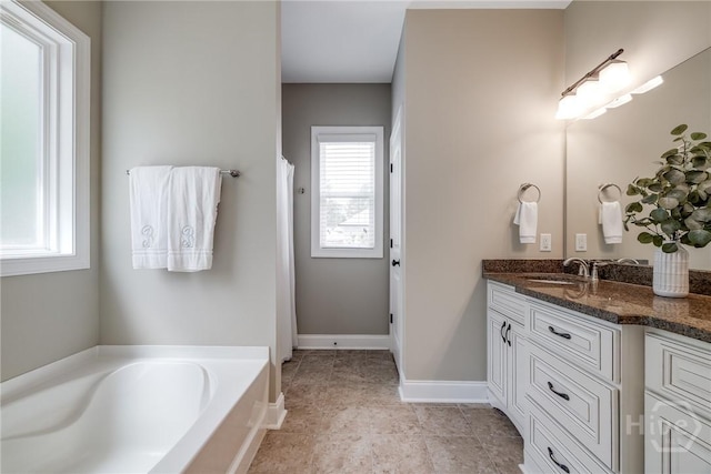 bathroom with plenty of natural light, vanity, a garden tub, and curtained shower