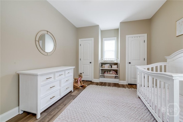 bedroom with wood finished floors and baseboards