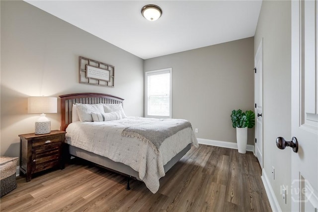 bedroom featuring wood finished floors and baseboards