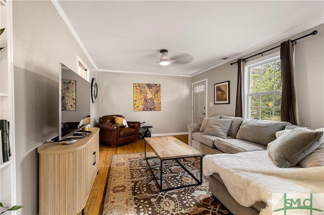 living room featuring light wood-style flooring, ceiling fan, and ornamental molding