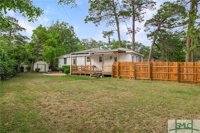rear view of property featuring a shed, an outbuilding, and a deck