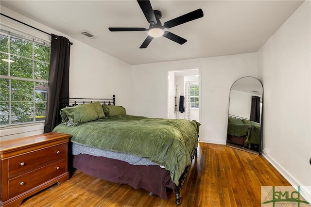 bedroom featuring wood finished floors, baseboards, and a ceiling fan