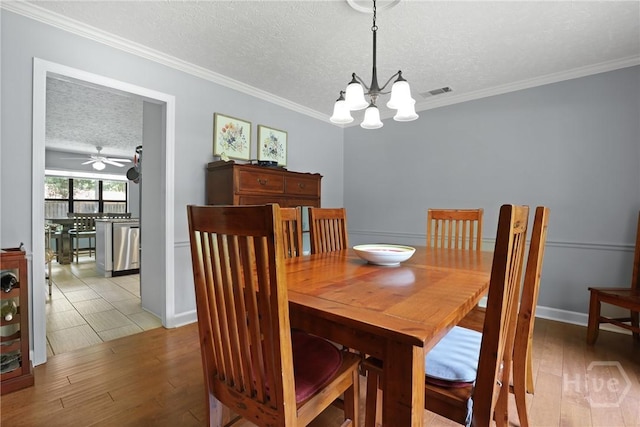 6 Ramsgate Rd, Savannah, GA 31419 - dining area with a textured ceiling, light wood finished floors, a chandelier, crown molding, and a ceiling fan
