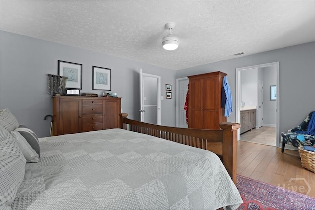 6 Ramsgate Rd, Savannah, GA 31419 - bedroom featuring wood finished floors, a textured ceiling, and baseboards
