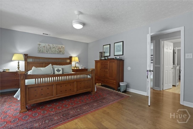6 Ramsgate Rd, Savannah, GA 31419 - bedroom with wood finished floors, a textured ceiling, and baseboards