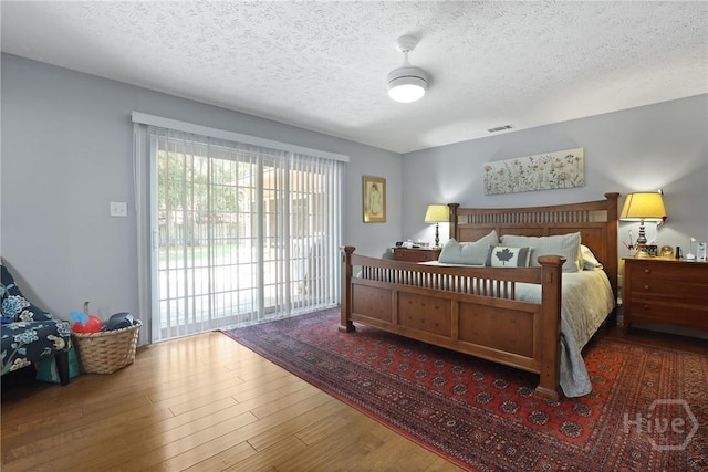 6 Ramsgate Rd, Savannah, GA 31419 - bedroom featuring a textured ceiling, wood finished floors, and access to exterior