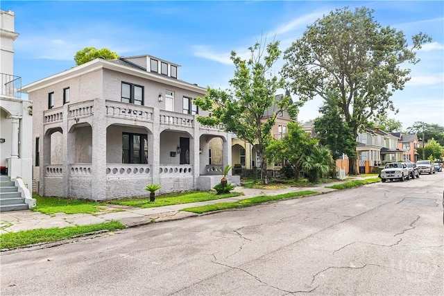 523 E 39th St, Savannah, GA 31401 - multi unit property featuring covered porch, stucco siding, and a residential view