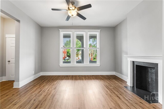 523 E 39th St, Savannah, GA 31401 - unfurnished living room with ceiling fan, baseboards, a fireplace, and wood finished floors