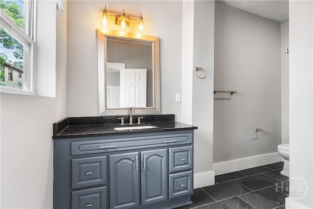 523 E 39th St, Savannah, GA 31401 - bathroom with vanity, toilet, tile patterned floors, and baseboards
