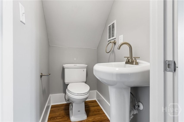 523 E 39th St, Savannah, GA 31401 - bathroom featuring toilet, lofted ceiling, wood finished floors, and baseboards