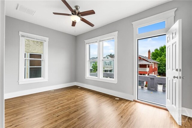 523 E 39th St, Savannah, GA 31401 - unfurnished room featuring plenty of natural light, wood finished floors, baseboards, and ceiling fan