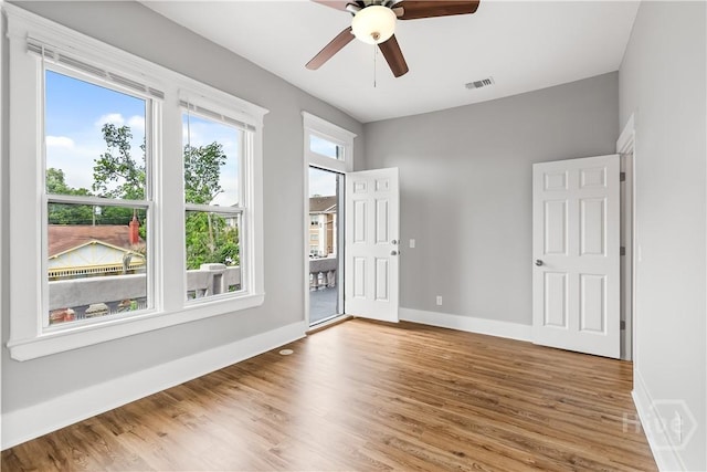 523 E 39th St, Savannah, GA 31401 - empty room featuring wood finished floors, a ceiling fan, and baseboards