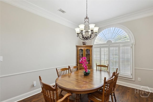 dining area featuring a chandelier, crown molding, wood finished floors, and baseboards