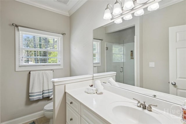 bathroom featuring ornamental molding, a shower stall, toilet, vanity, and baseboards