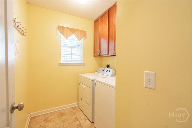laundry room featuring cabinet space, washing machine and dryer, and baseboards