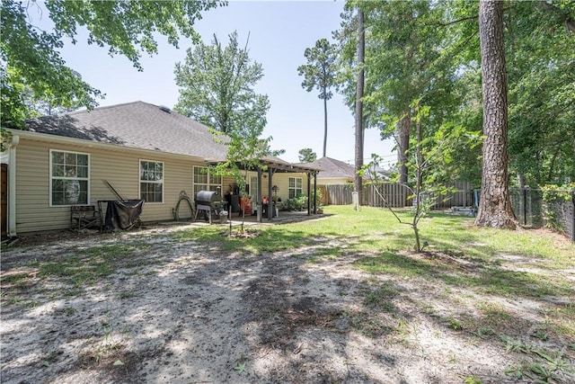 rear view of house featuring a fenced backyard and a patio area