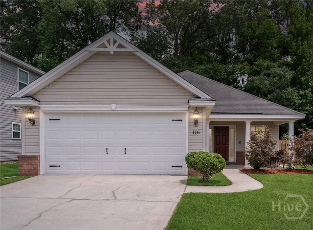 view of front facade with driveway, a garage, a front lawn, and a shingled roof