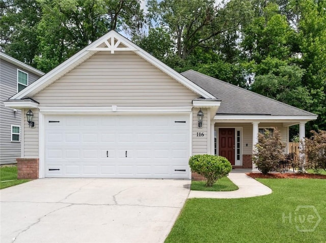 view of front of house with concrete driveway, a garage, a shingled roof, and a front lawn