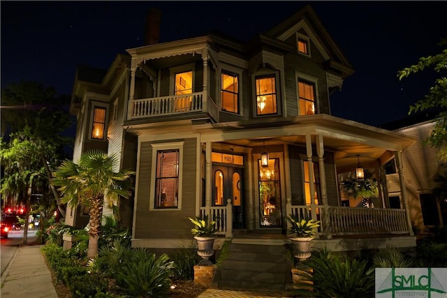 102 E 38th St, Savannah, GA 31401 - exterior entry at night with a balcony and a porch