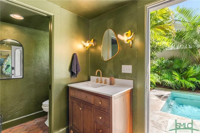 102 E 38th St, Savannah, GA 31401 - bathroom featuring vanity, toilet, a textured wall, and baseboards