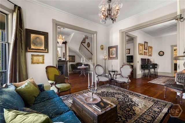 102 E 38th St, Savannah, GA 31401 - living area featuring wood finished floors, a chandelier, stairway, crown molding, and baseboards