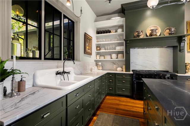 102 E 38th St, Savannah, GA 31401 - bar with a sink, dark wood finished floors, black gas stove, and decorative backsplash