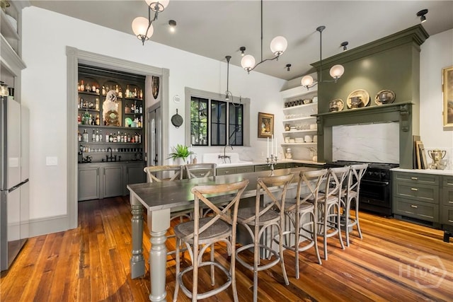 102 E 38th St, Savannah, GA 31401 - kitchen featuring hardwood / wood-style flooring, open shelves, a sink, freestanding refrigerator, and green cabinets