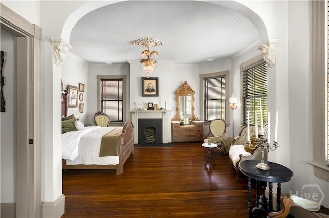 102 E 38th St, Savannah, GA 31401 - bedroom with arched walkways, wood finished floors, ornamental molding, and a fireplace with flush hearth