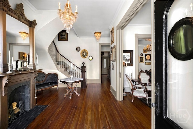 102 E 38th St, Savannah, GA 31401 - entrance foyer with a chandelier, stairway, wood finished floors, ornamental molding, and a fireplace with flush hearth