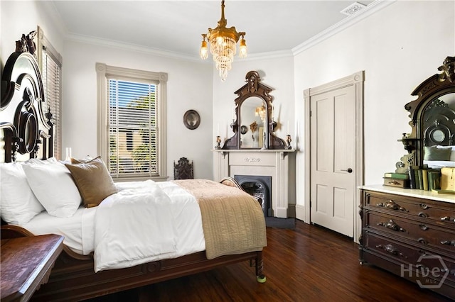 102 E 38th St, Savannah, GA 31401 - bedroom featuring crown molding, dark wood-type flooring, a chandelier, and a fireplace