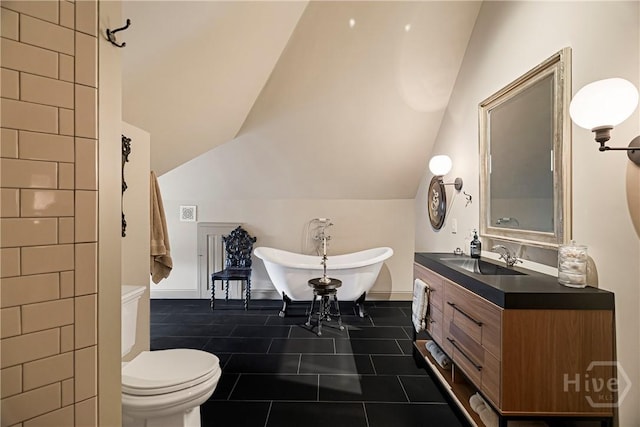 102 E 38th St, Savannah, GA 31401 - full bath with vaulted ceiling, a freestanding bath, vanity, and toilet