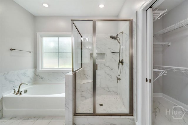 bathroom featuring marble finish floors, a marble finish shower, a bath, and recessed lighting