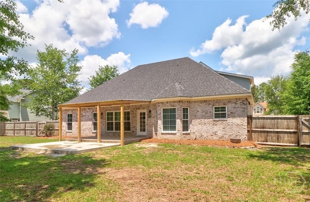 rear view of house featuring a patio, brick siding, and a shingled roof