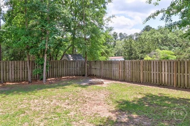 view of yard with a fire pit