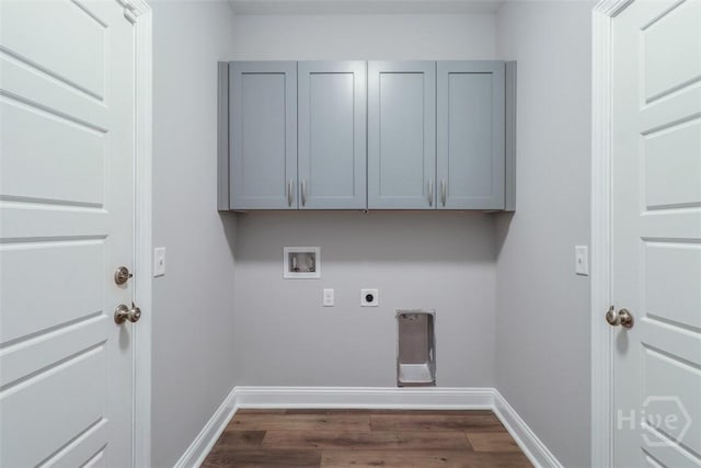 washroom with electric dryer hookup, hookup for a washing machine, dark wood-type flooring, and baseboards