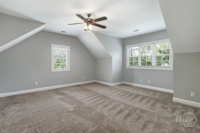 bonus room featuring carpet floors, lofted ceiling, a ceiling fan, and baseboards