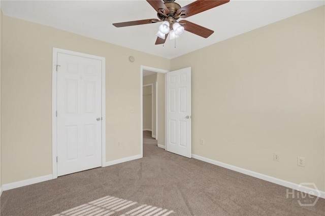 450 Canyon Oak Loop, Richmond Hill, GA 31324 - unfurnished bedroom with carpet floors, baseboards, and a ceiling fan