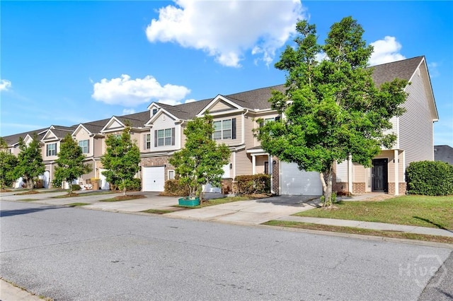 450 Canyon Oak Loop, Richmond Hill, GA 31324 - townhome / multi-family property with driveway, a residential view, brick siding, and an attached garage