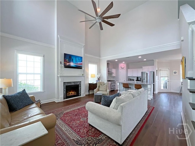 66 Misty Marsh Dr, Savannah, GA 31419 - living room featuring high vaulted ceiling, a ceiling fan, dark wood-type flooring, a lit fireplace, and plenty of natural light