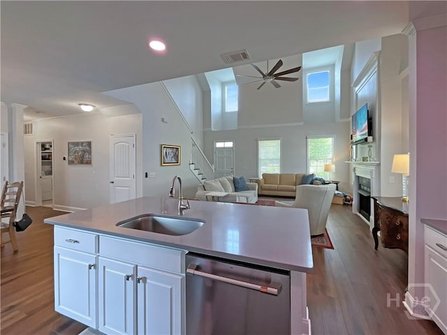 66 Misty Marsh Dr, Savannah, GA 31419 - kitchen with dishwasher, ceiling fan, a fireplace, open floor plan, and dark wood-style flooring