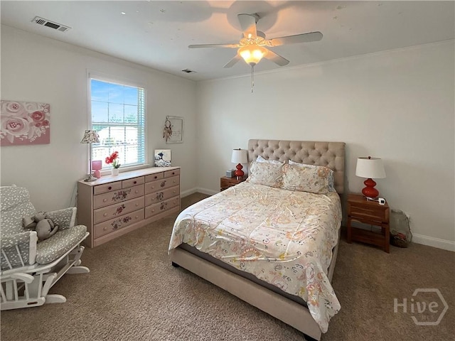 carpeted bedroom with ceiling fan, baseboards, and ornamental molding