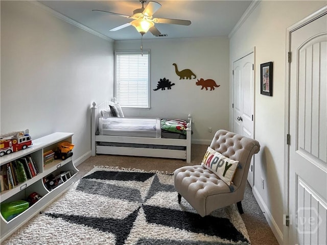 bedroom with crown molding, carpet floors, baseboards, and a ceiling fan