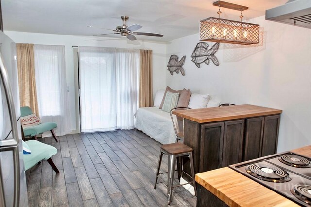 1217 Bay St Unit 131A, Tybee Island, GA 31328 - bedroom with dark wood finished floors and freestanding refrigerator
