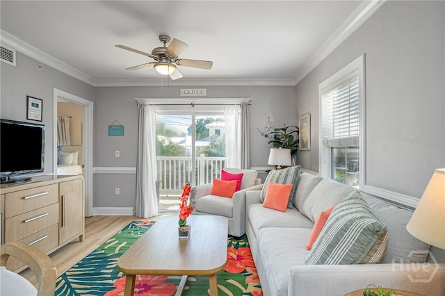 18 Silver Ave Unit 1, Tybee Island, GA 31328 - living area featuring plenty of natural light, a ceiling fan, ornamental molding, and light wood-type flooring