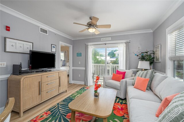 18 Silver Ave Unit 1, Tybee Island, GA 31328 - living area featuring healthy amount of natural light, light wood-style flooring, a ceiling fan, and ornamental molding